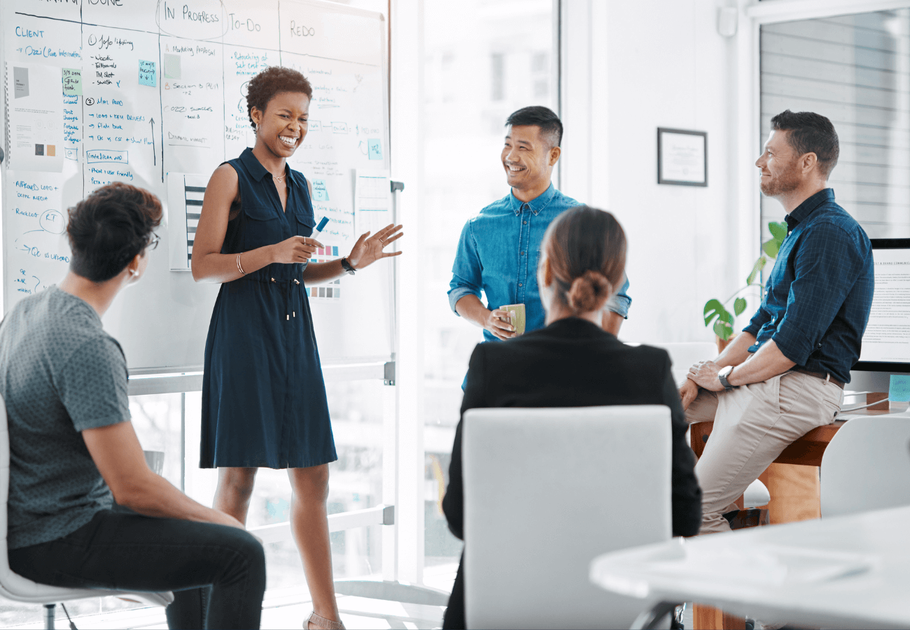 Work day in which 5 people debate in front of a blackboard