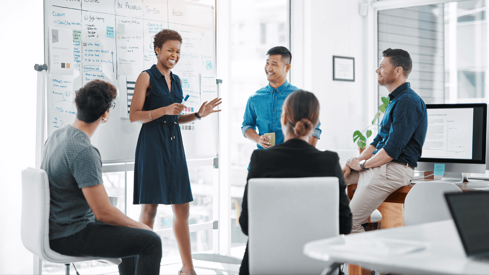 Work day in which 5 people debate in front of a blackboard